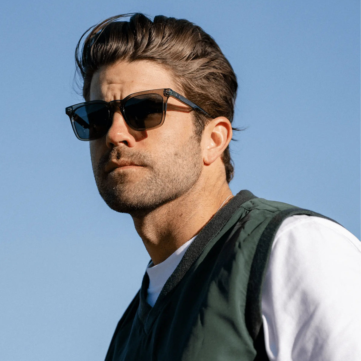 Crystal Agave Green / Grey || Rectangular modern prescription sunglasses with crystal agave green acetate frame and grey lenses worn outdoors by man