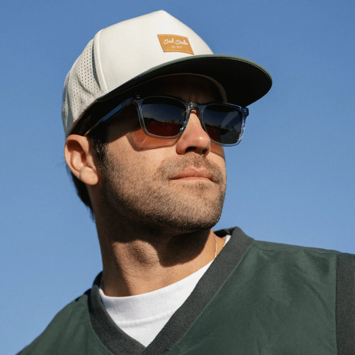 Denim Blue / Amber || Rectangular prescription sunglasses with denim blue frame and brown lenses worn outdoors by man