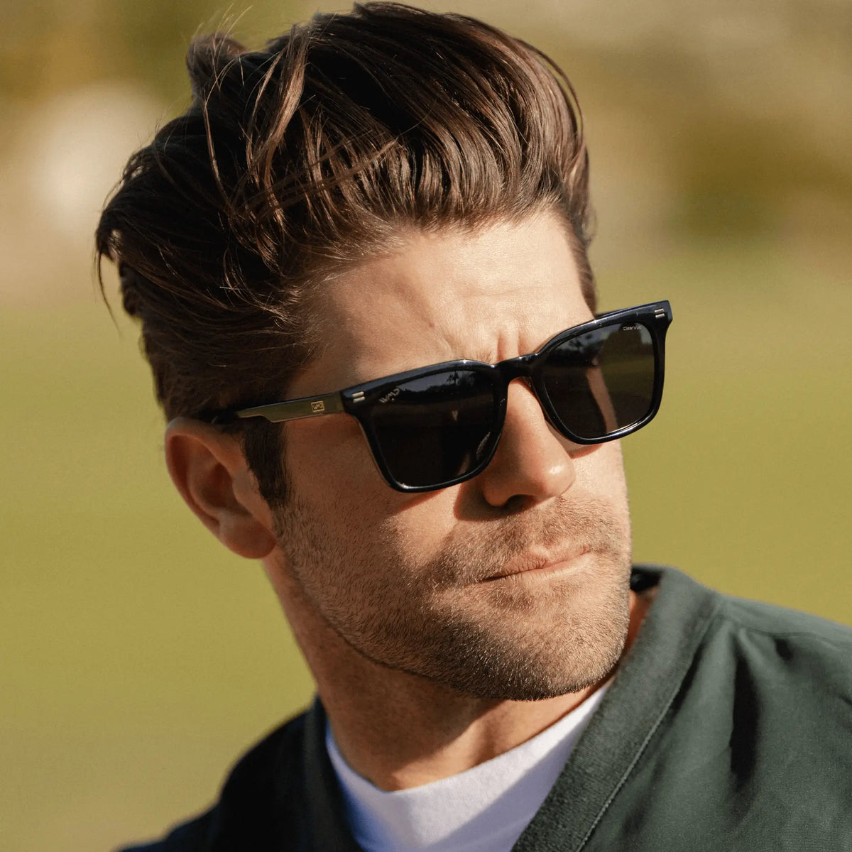 Black / Grey || Square modern prescription sunglasses with black acetate frame and grey lenses worn by man outdoors