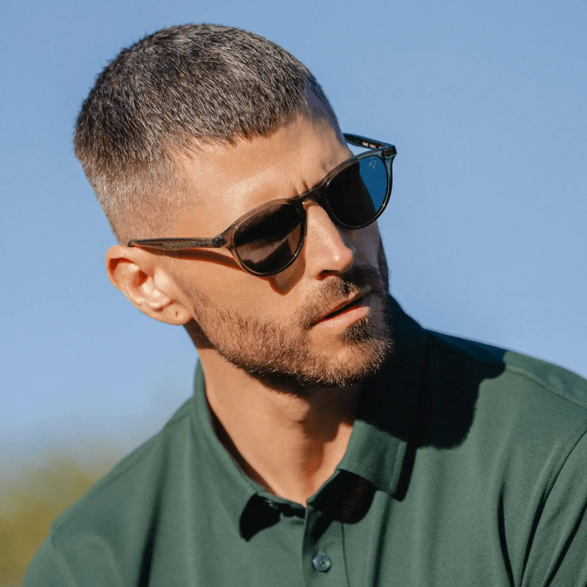 Crystal Agave Green / Grey || Modern prescription sunglasses with round frame style, crystal agave green acetate frame color, and keyhole bridge worn by a man outdoors