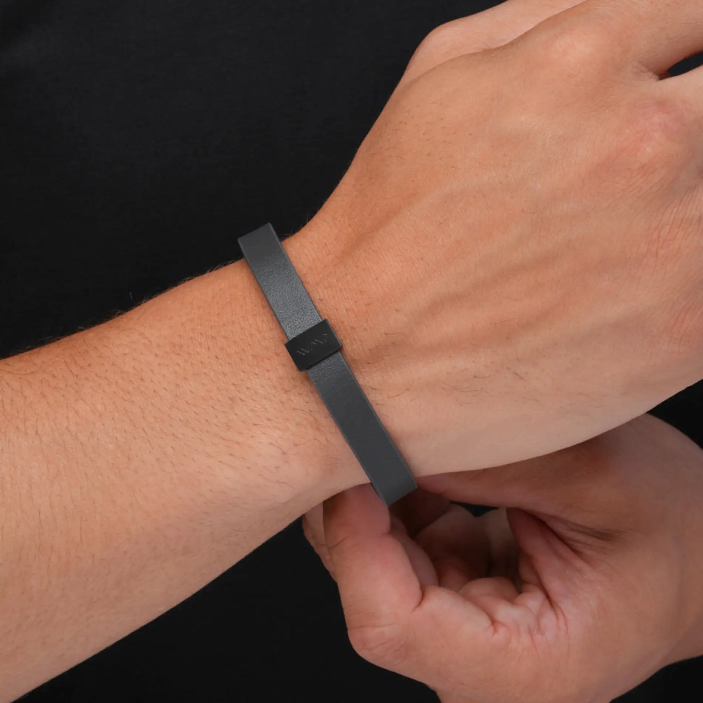 Black Metal / Grey Leather || Close up of model wearing Grey Leather Cuff Bracelet with Black Metal Accents.