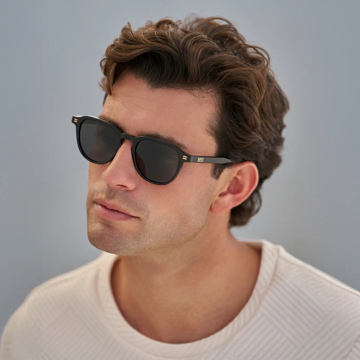 Black / Grey || Men's Round Prescription Sunglasses with Black Frame and Grey Lenses worn by a man in natural light