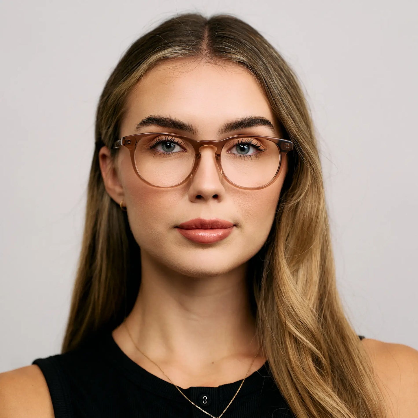 Light Brown || Female Model wearing Women's Retro-Inspired Oval Blue Light Blocking Glasses with a Light Brown Acetate Frame and Clear Lens