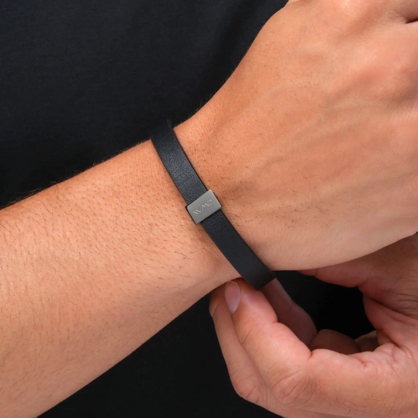 Gun Metal / Black Leather || Close up of model wearing Black Leather Cuff Bracelet with Gunmetal Metal Accents.
