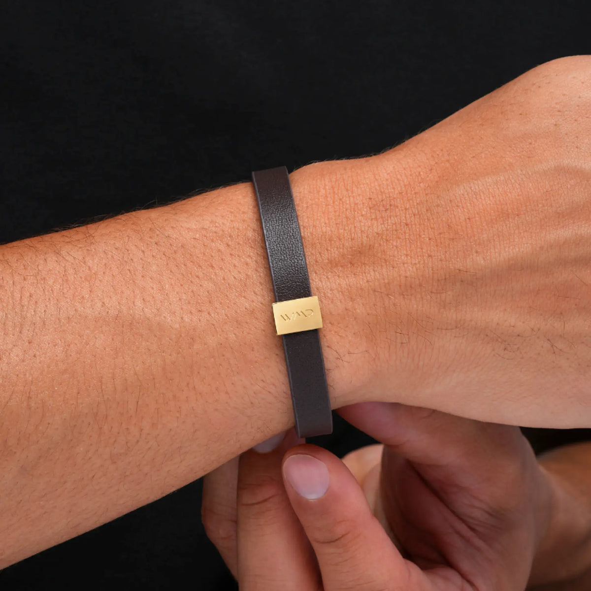 Gold / Dark Brown Leather || Close up of model wearing Brown Leather Cuff Bracelet with Gold Metal Accents.