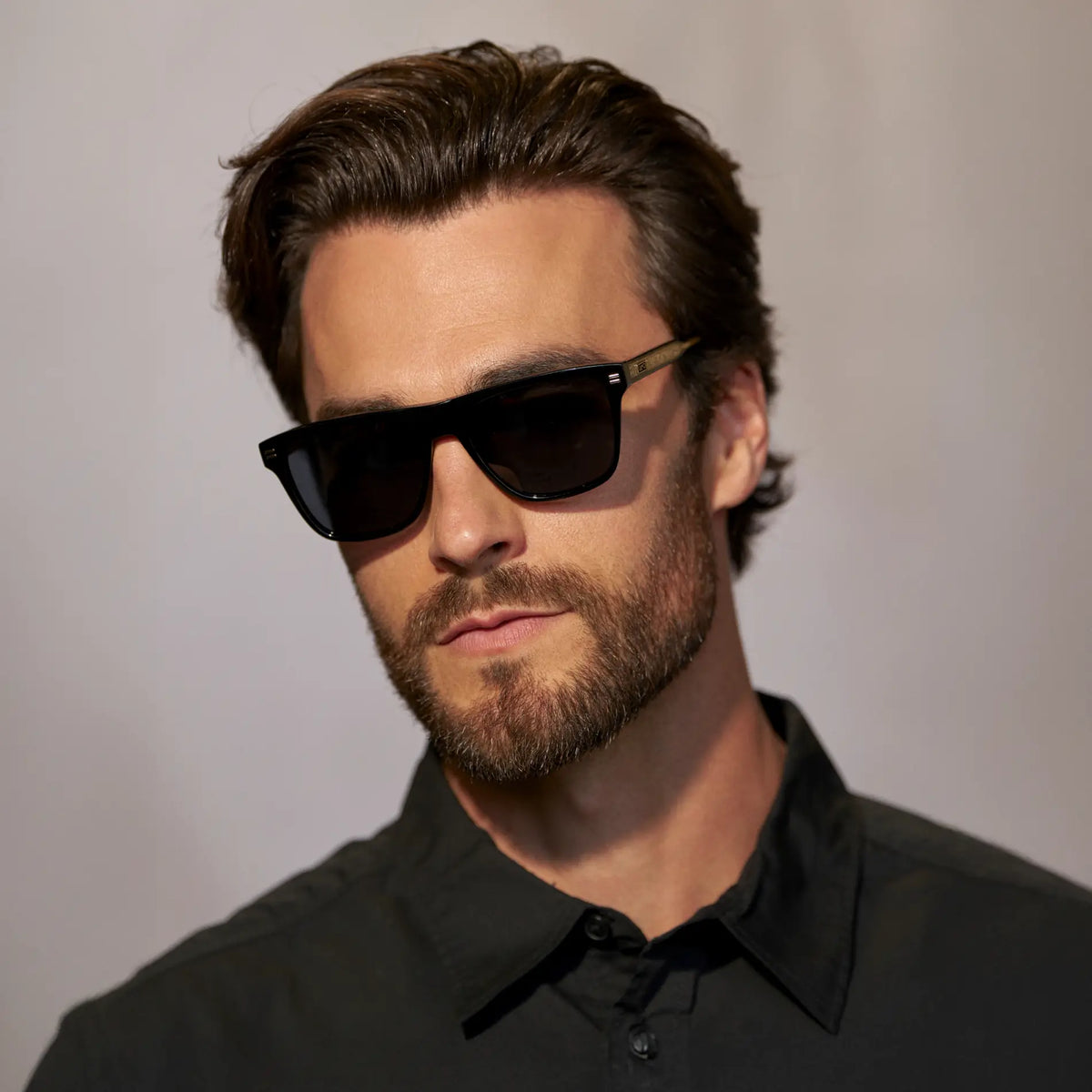 Black / Triple Black Lens || Front view of man wearing Rectangular Polarized Sunglasses with Black Frame and Black Lens against a grey background