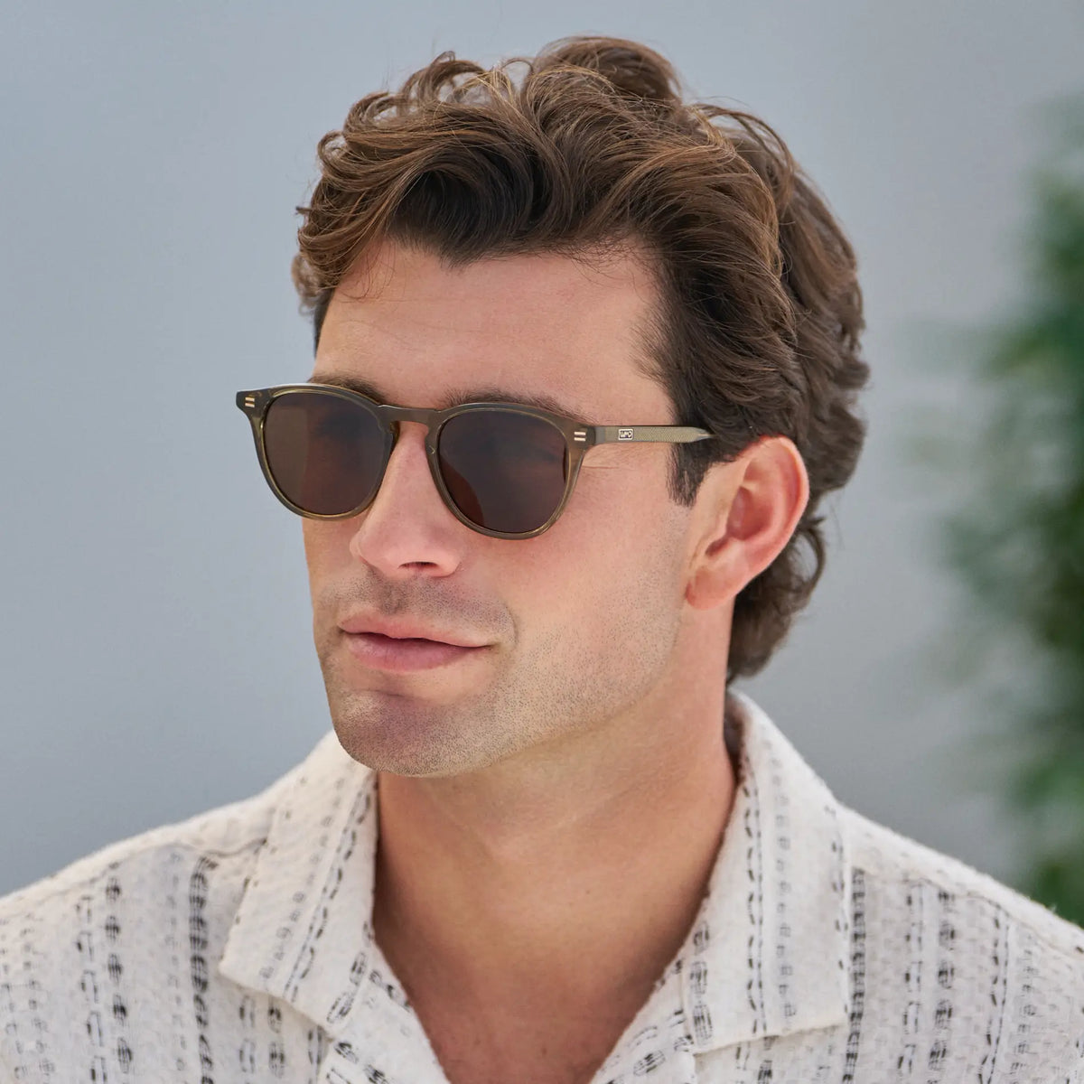 Khaki Green / Amber || Men's Round Prescription Sunglasses with Khaki Green Frame and Amber Lenses worn by a man outdoors