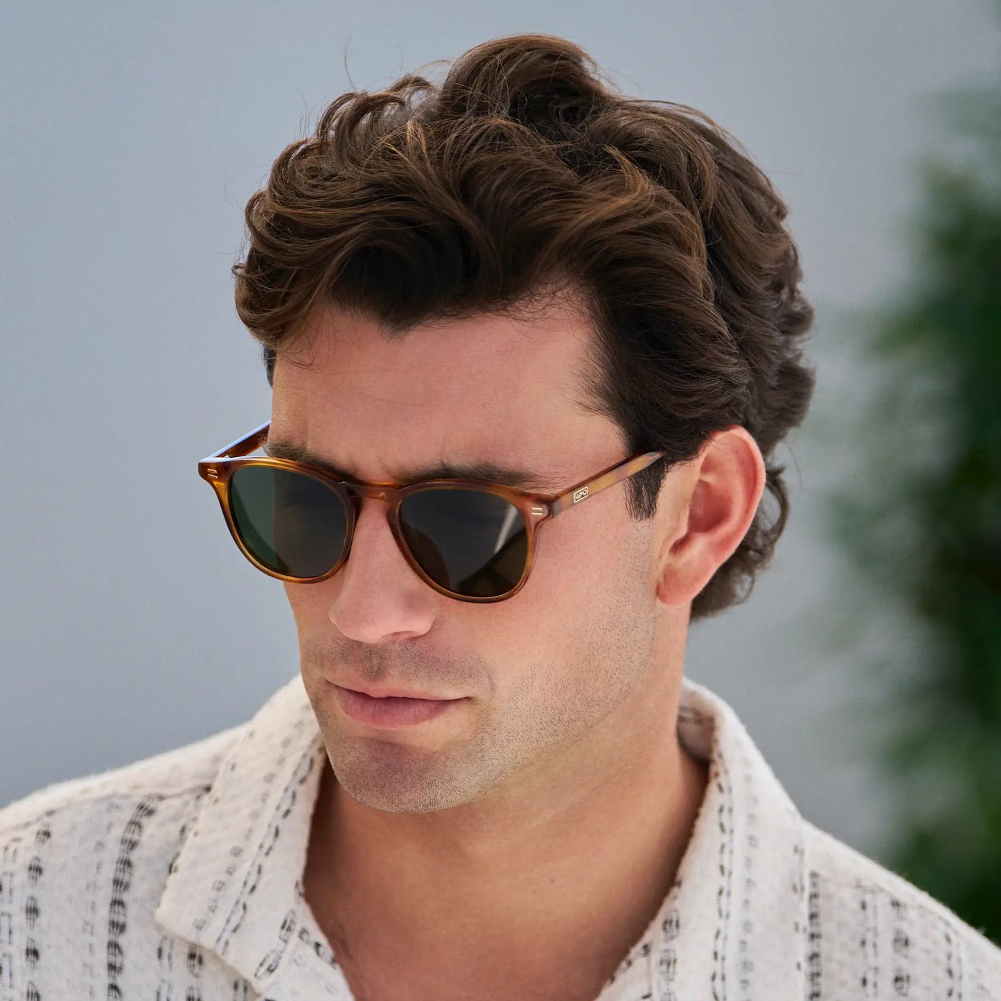 Honey Tortoise / Smoke Green Lens || Model wearing Men's Round Polarized Sunglasses with Honey Tortoise Frame and Green Lenses