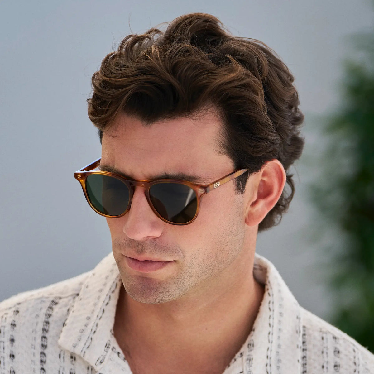 Honey Tortoise / G15 || Model wearing Men's Round Prescription Sunglasses with Honey Tortoise Frame and Green Lenses on a white background