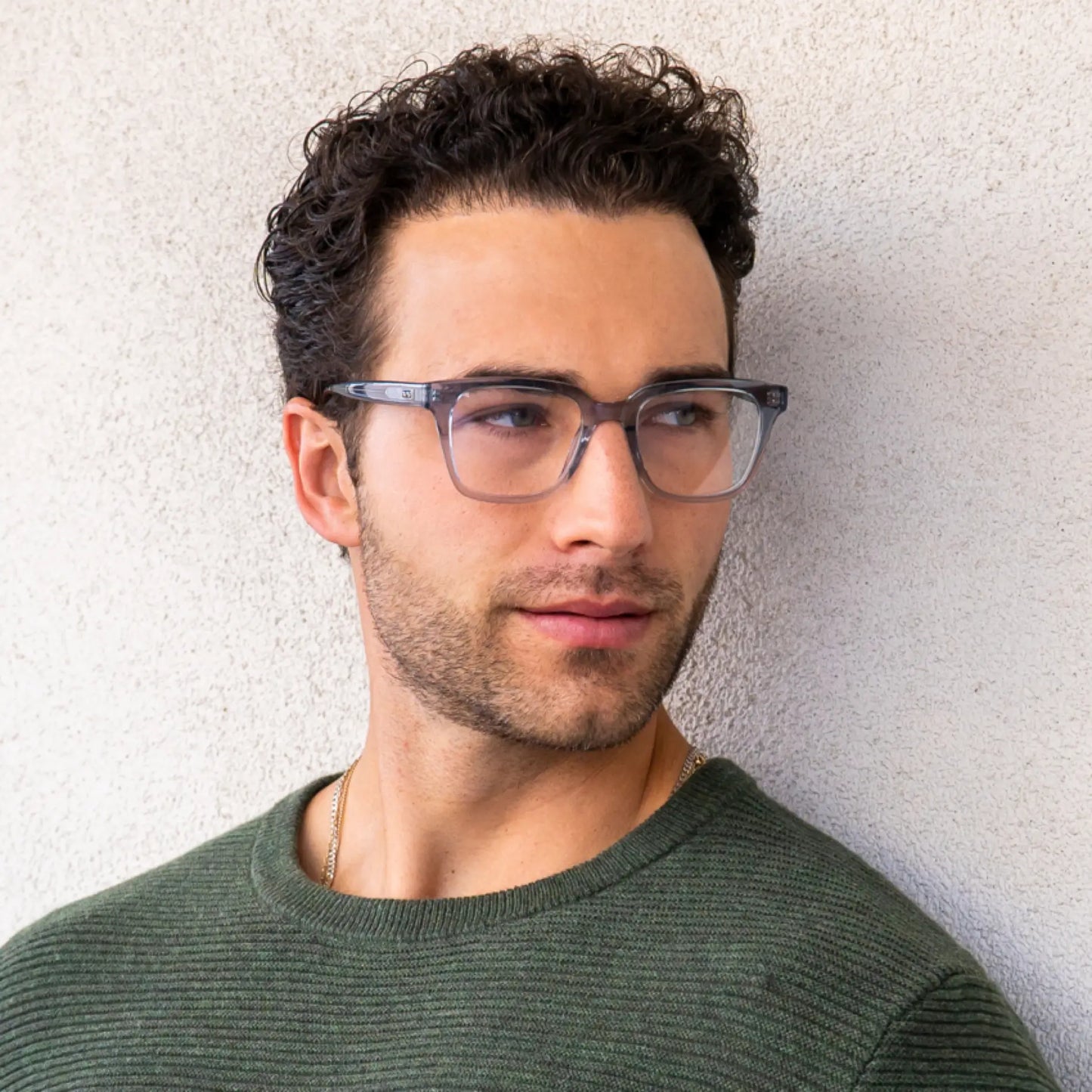 Denim Blue || Carson translucent blue square frame blue light glasses worn by man in green sweater against light wall