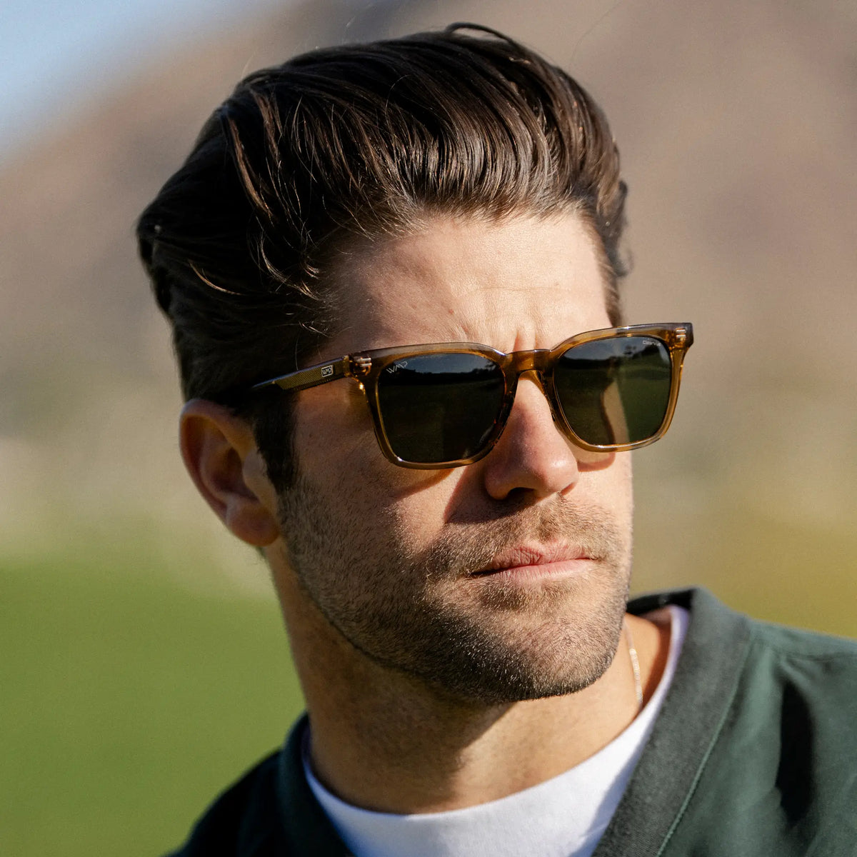 Crystal Brown / G15 || Rectangular prescription sunglasses with crystal brown acetate frame and keyhole bridge worn outdoors by man