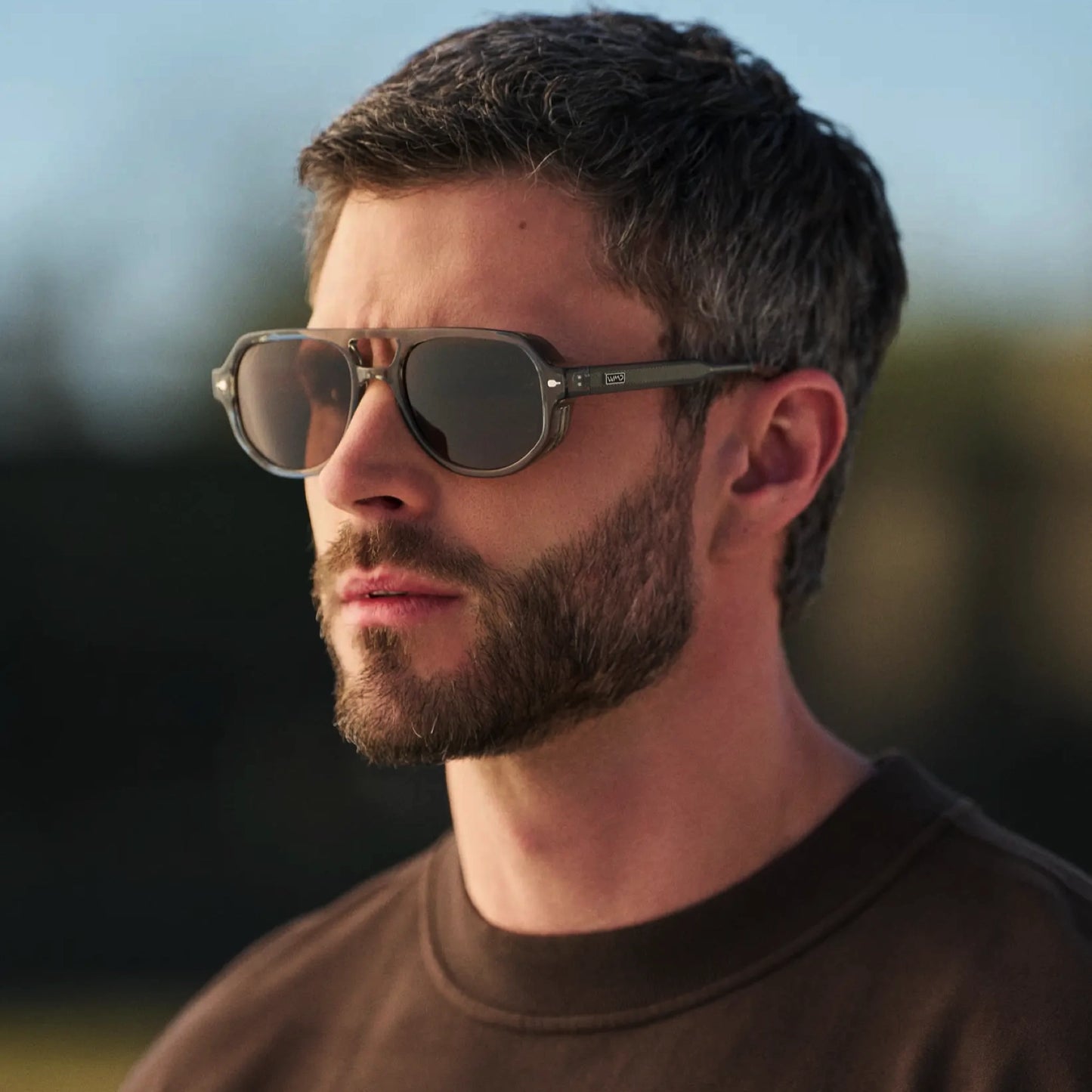 Sage Green / Brown Lens || Man wearing Geometric Aviator Sunglasses with Sage Green Frame and Brown Lens outdoors