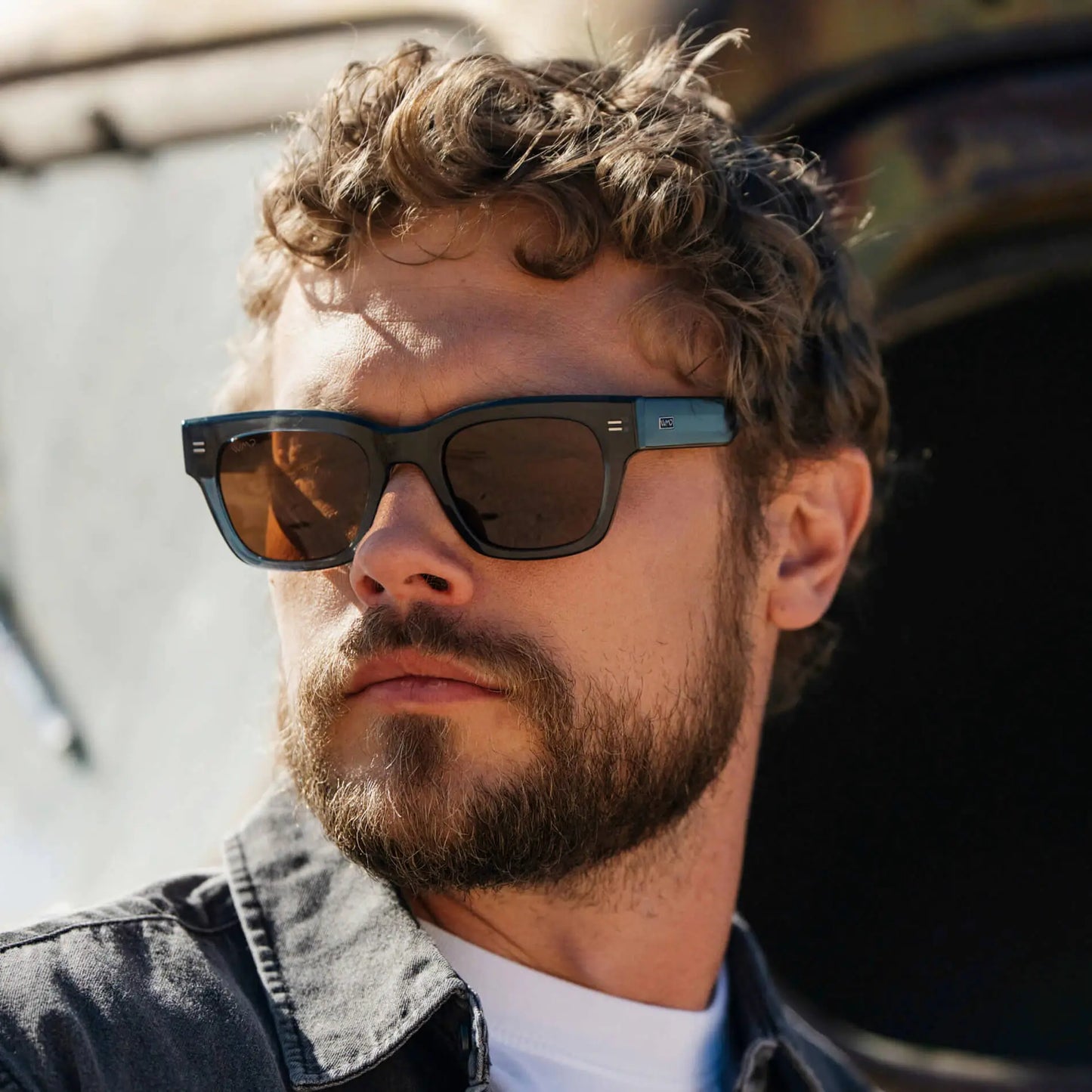 Crystal Steel Blue / Amber || Model wearing Men's Oversized Rectangular Prescription Sunglasses with Crystal Steel Blue Acetate Frame and Amber Prescription Lens