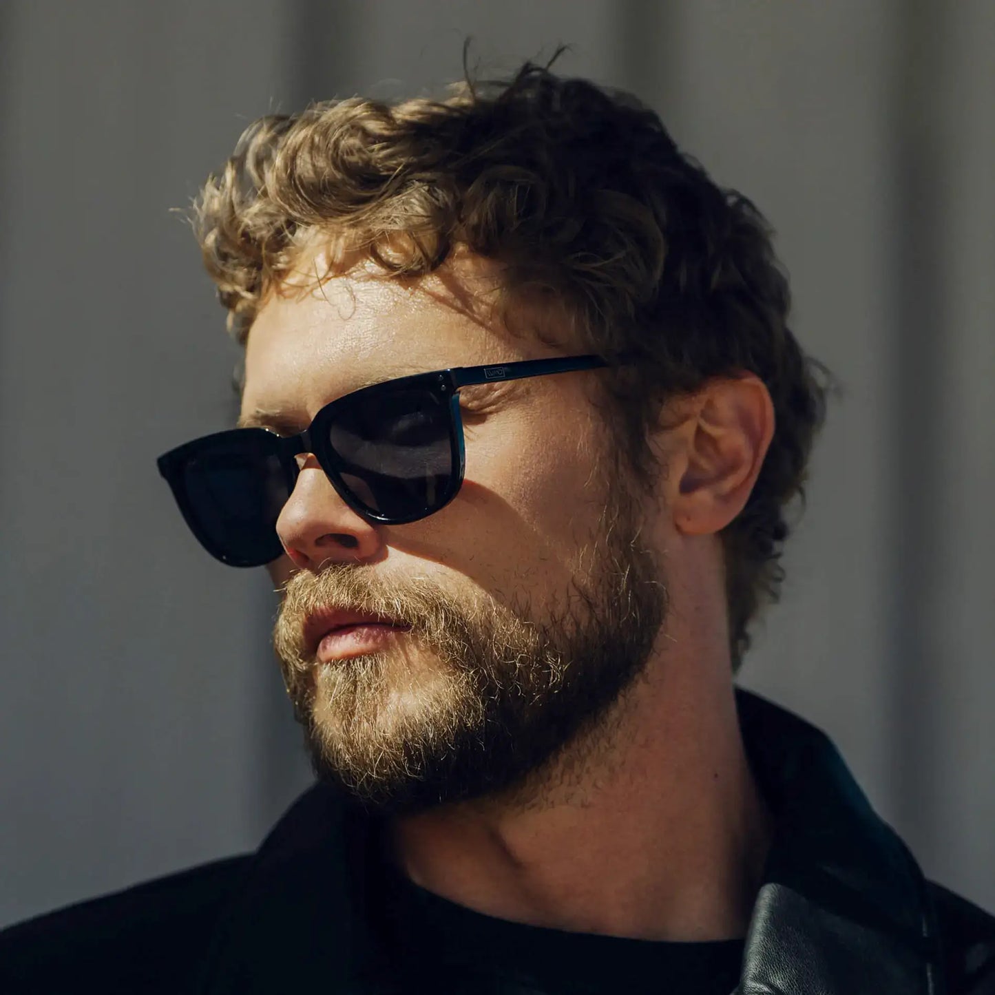 Black / Grey || Square prescription sunglasses with black acetate frame and grey lenses worn by man outdoors