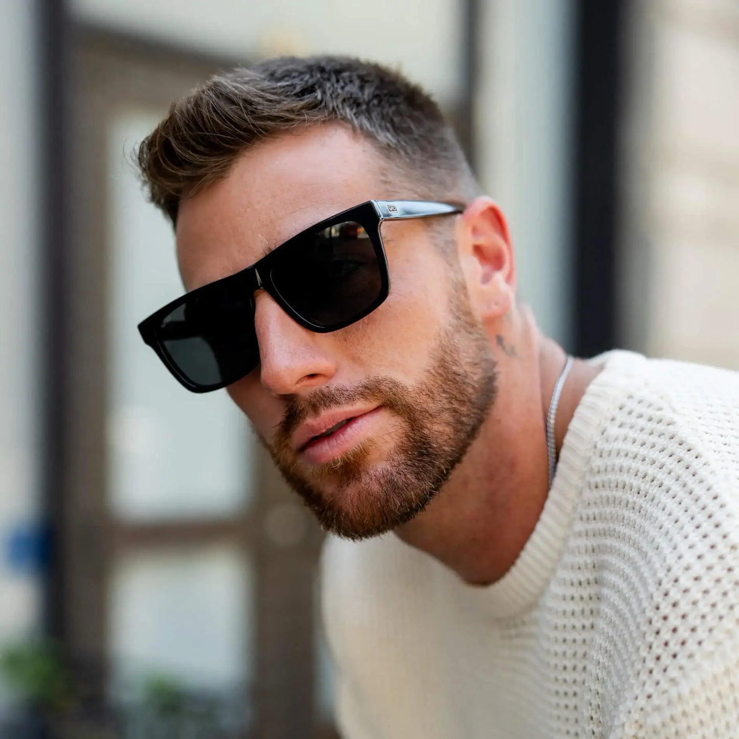 Black / Grey || Square prescription sunglasses with black acetate frame, grey lenses and straight browline worn by man outdoors