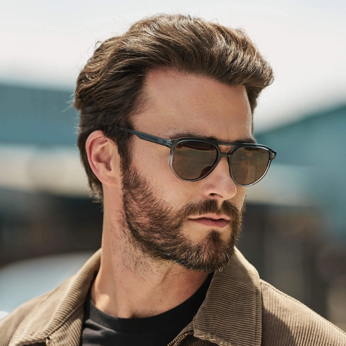 Chambray Blue / Amber || Model wearing Men's Modern Aviator Prescription Sunglasses with Blue Acetate Frame and Brown Prescription Lens