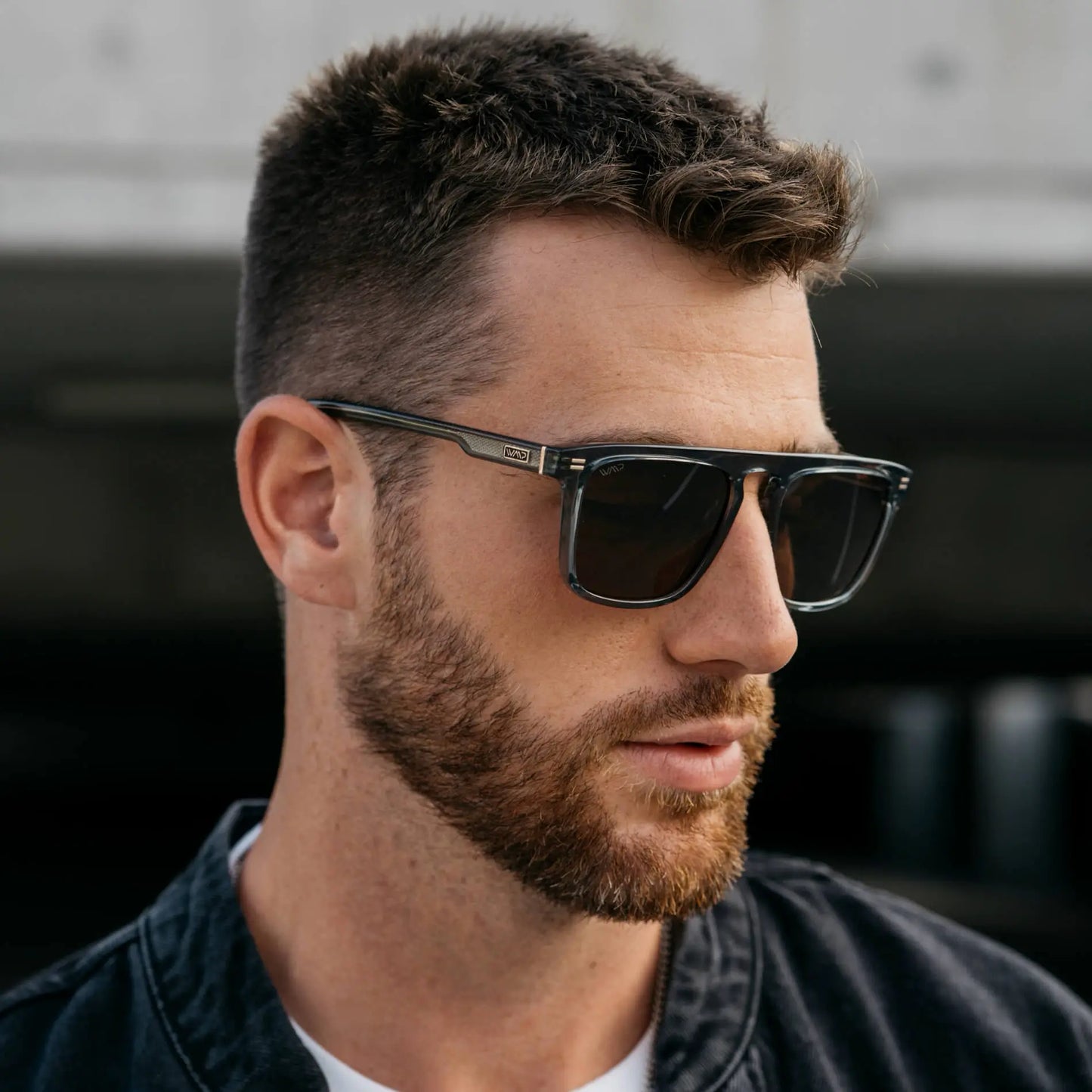 Crystal Stone Blue / Amber || Model wearing Men's Sleek and Modern Prescription Sunglasses with Crystal Blue Frame and Brown Lenses