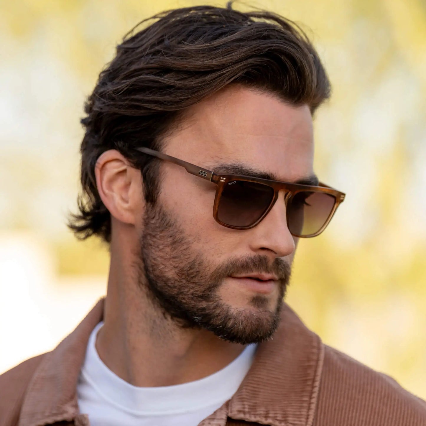 Frosted Oakwood Brown / Amber || Model wearing Men's Sleek and Modern Prescription Sunglasses with Frosted Oakwood Brown Frame and Amber Lenses
