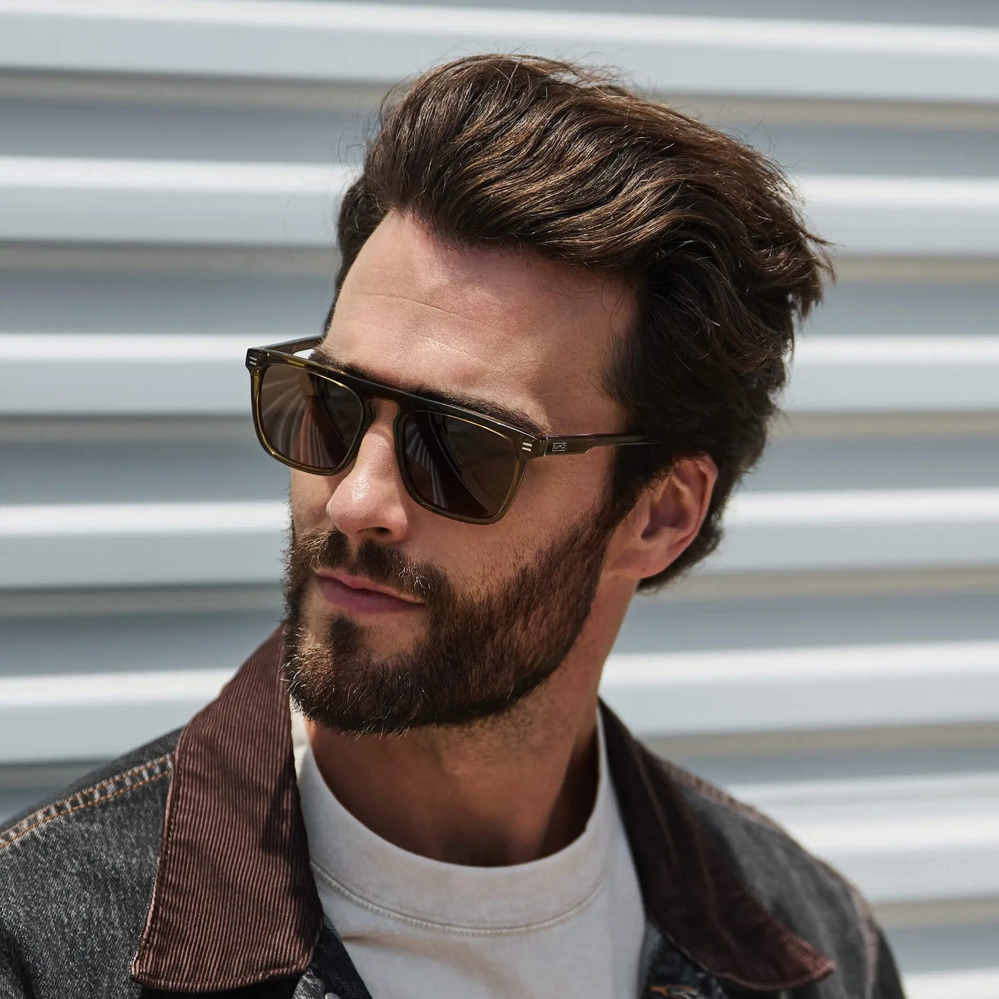 Crystal Verde / Amber || Model wearing Men's Sleek and Modern Prescription Sunglasses with Crystal Green Frame and Brown Lenses