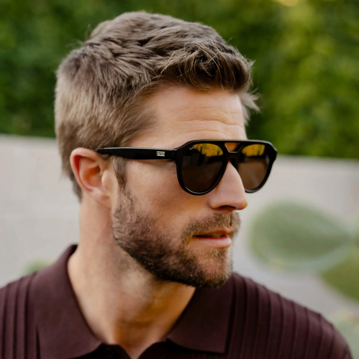 Black / Amber || Model wearing Men's Aviator Style Prescription Sunglasses with Black Frame and Brown Prescription Lenses