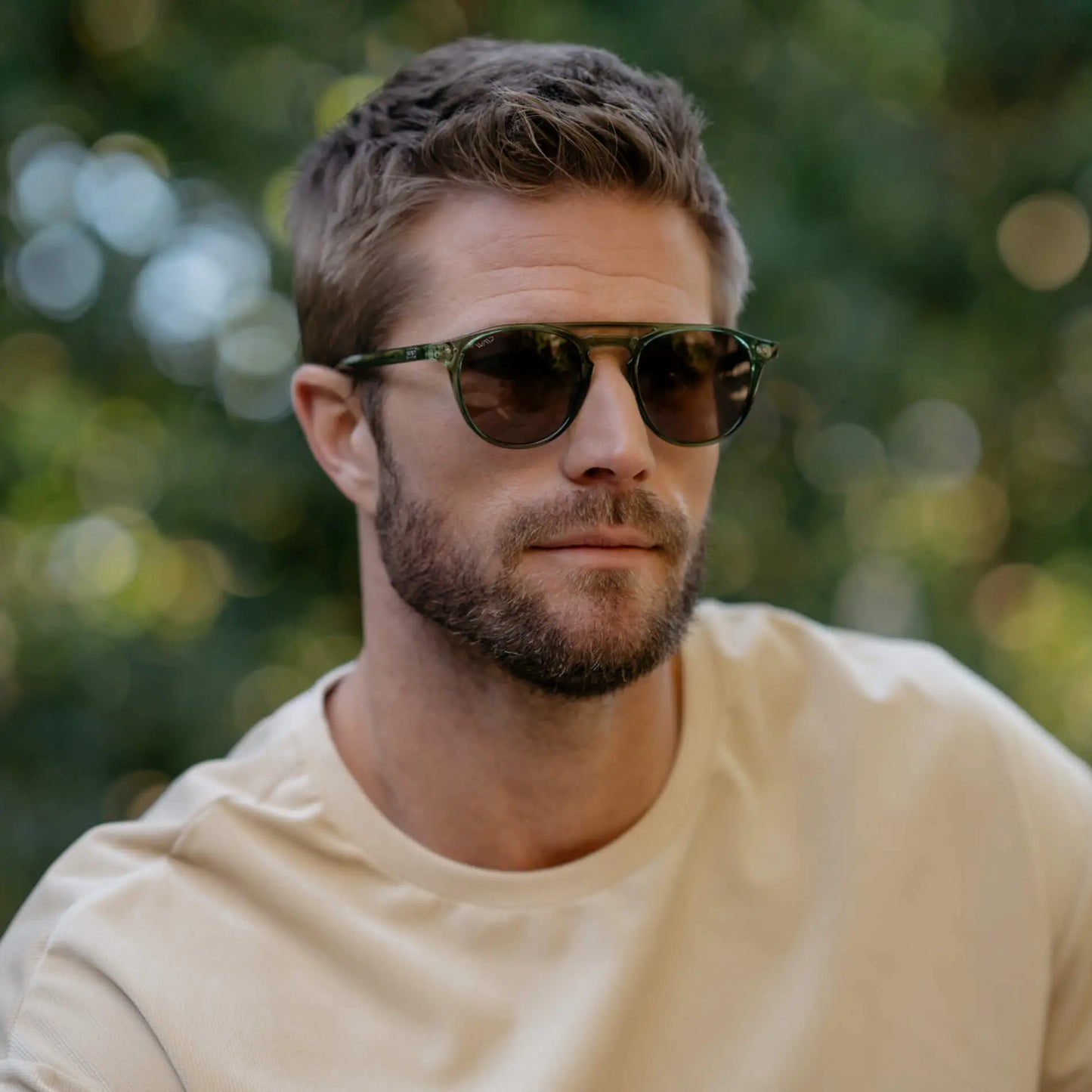 Emerald Green / Amber || Model wearing Men's Green Round Frame Prescription Sunglasses with Brown Lenses