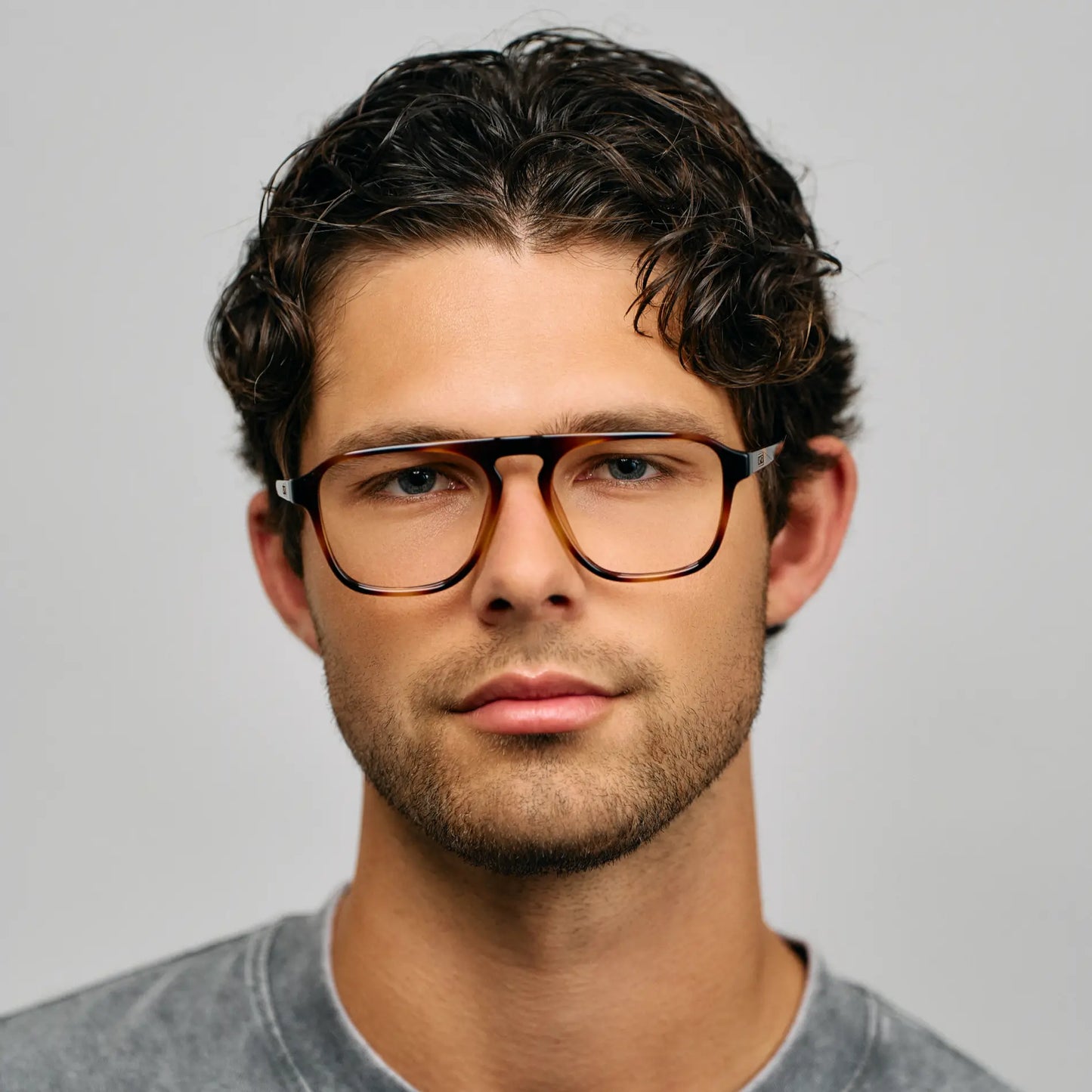 Whiskey Brown Tortoise || Modern aviator prescription glasses with brown tortoise frame and keyhole bridge worn by man with curly hair