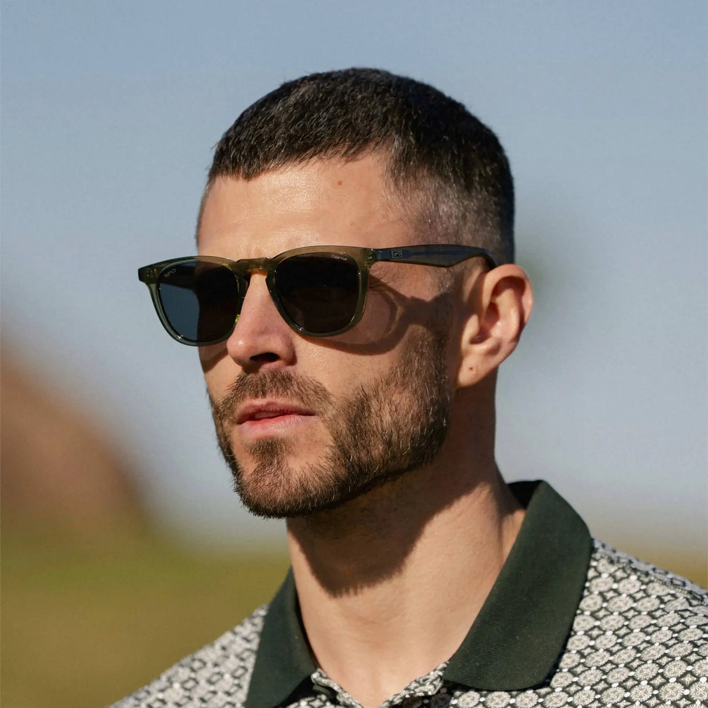 Crystal Agave Green / Grey || Model wearing Men's Round Prescription Sunglasses with Green Frame and Grey Lens