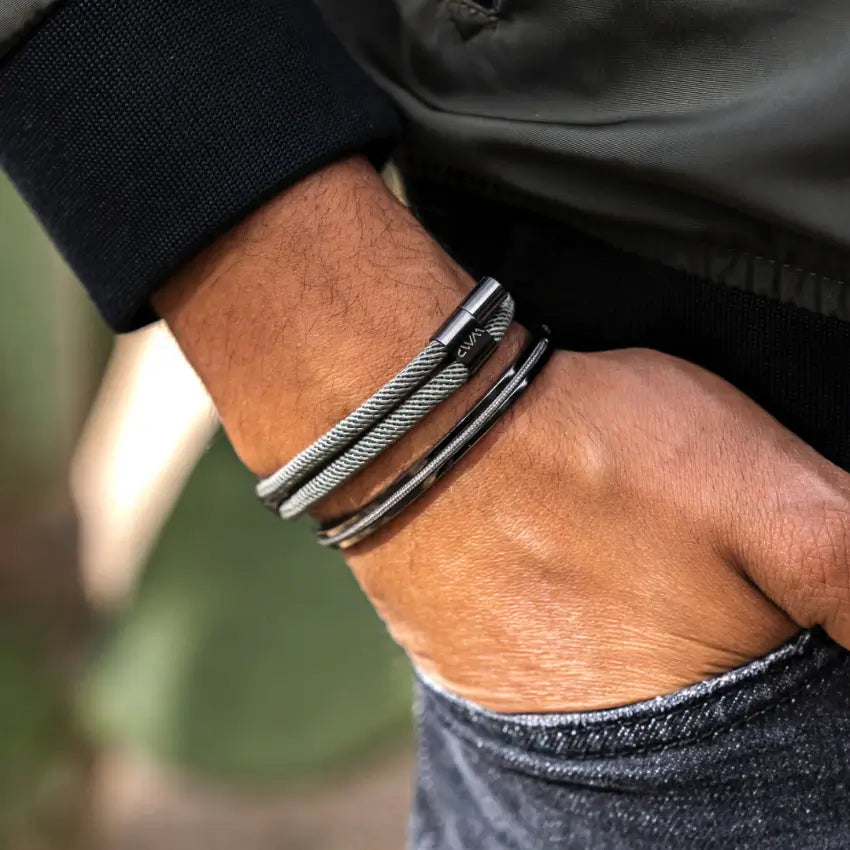 Close-up of a man's wrist wearing a modern minimal men's bracelet set with stainless steel and poly rope detailing
