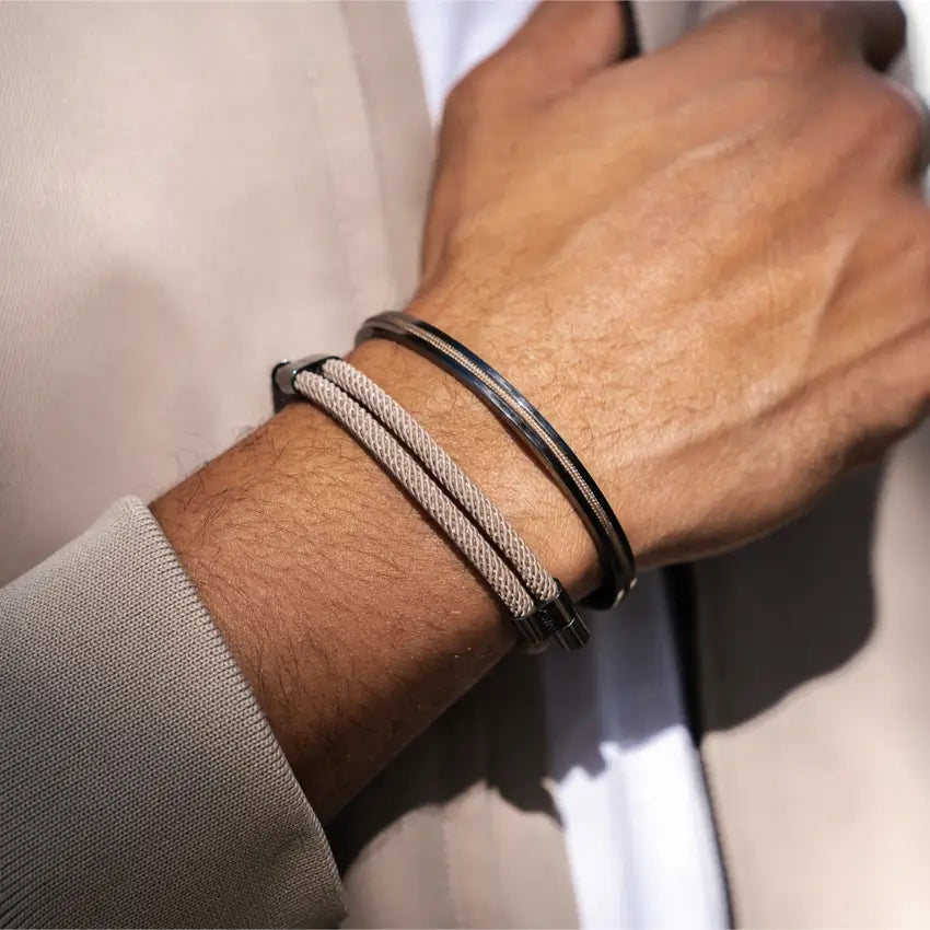 Close-up of a wrist wearing a modern minimal men's bracelet set with poly rope and stainless steel details