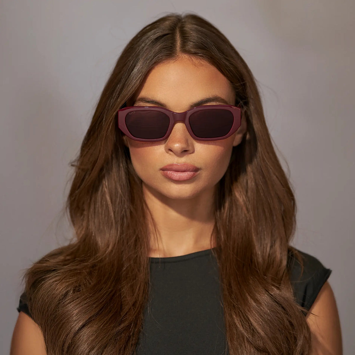 Black Cherry Red / Dark Brown Lens || Front view of Woman wearing Rectangular Cateye Polarized Sunglasses with Red frame and dark brown lens against a grey background
