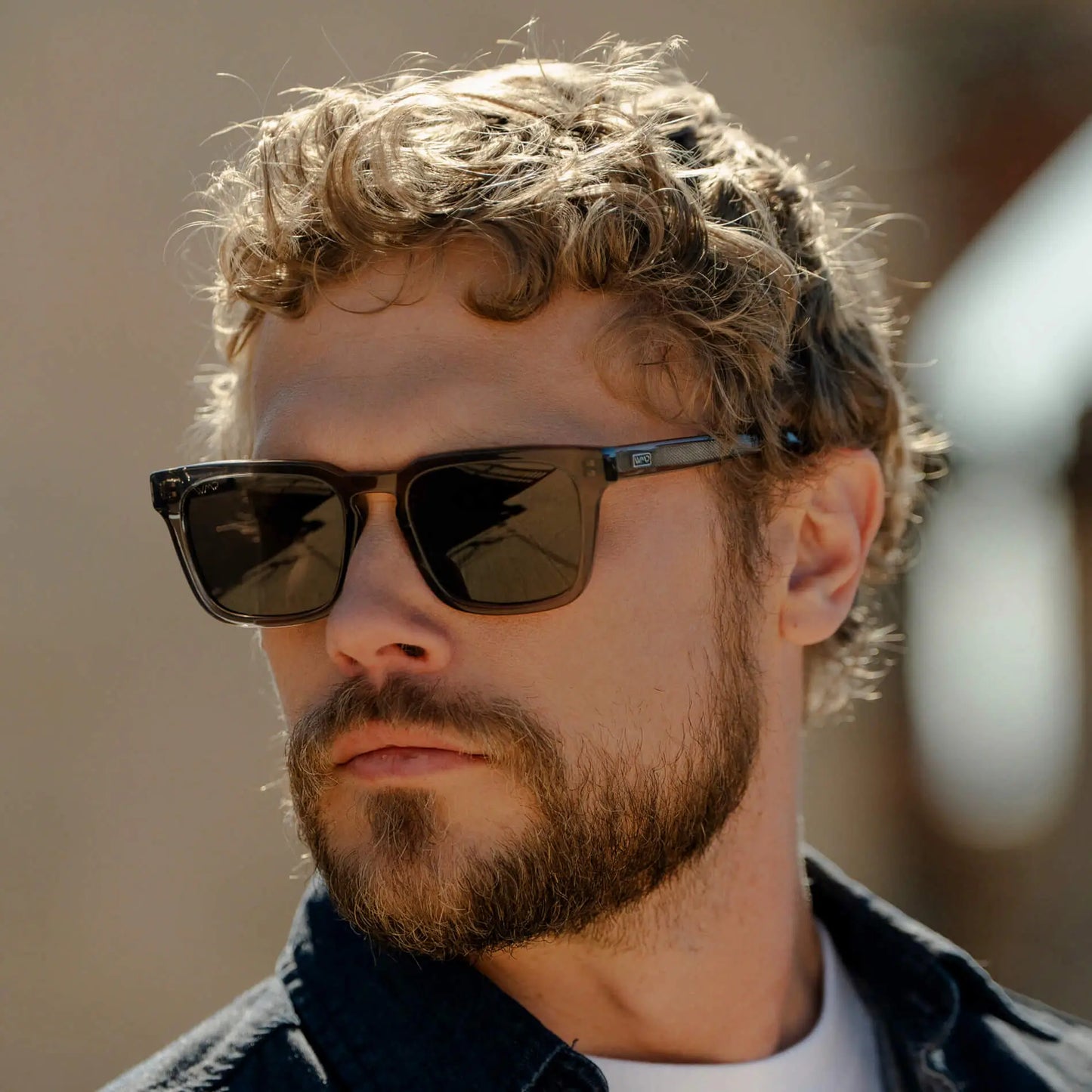 Crystal Gunmetal / Amber || Model wearing Men's Sleek Square Prescription Sunglasses with Crystal Gunmetal Acetate Frame and Amber Prescription Lens