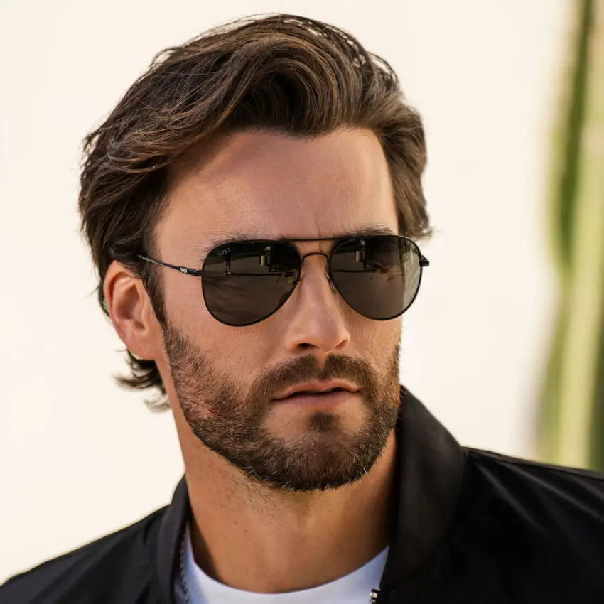 Man wearing classic aviator polarized sunglasses with stainless steel frame and dark lenses