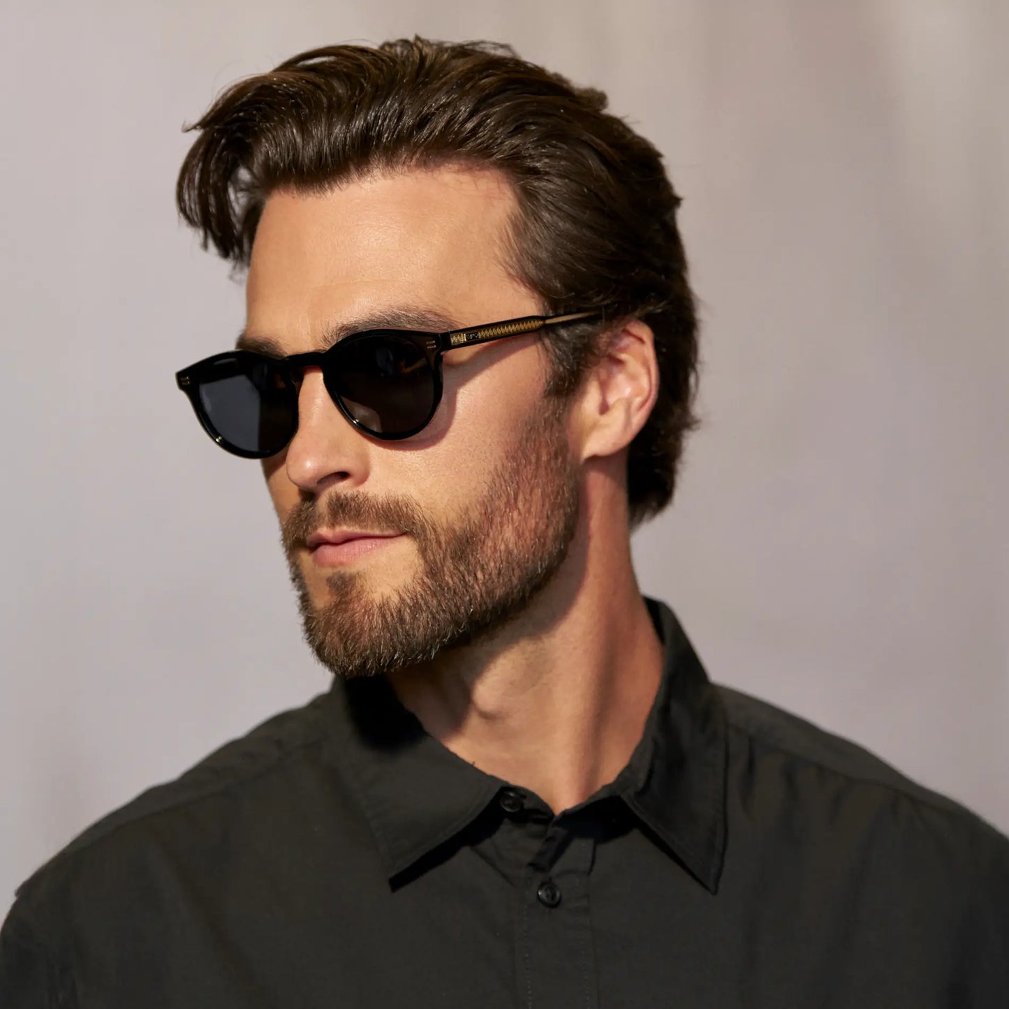 Black / Grey || Side view of model wearing Men's Round Prescription Sunglasses with Black Frame and Grey Lens