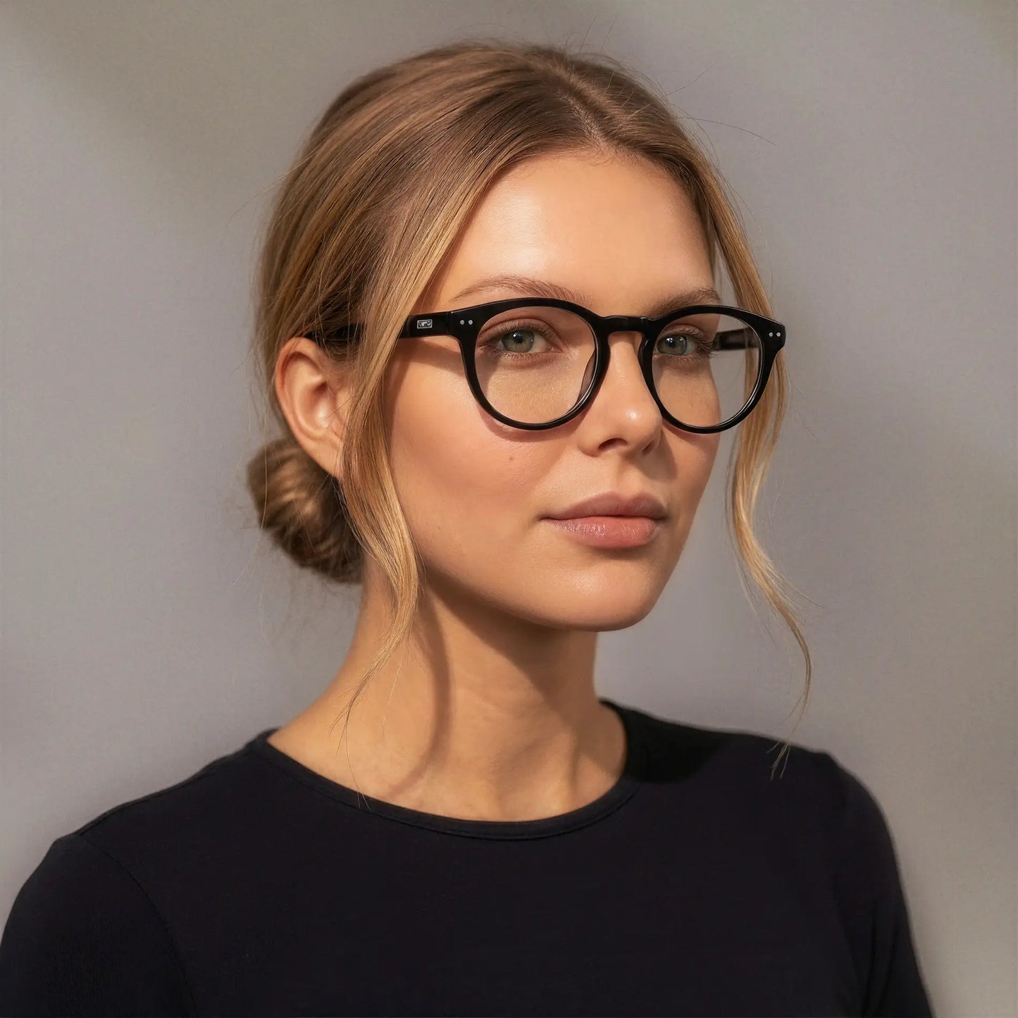 Black || Woman wearing Round Prescription Glasses with Black Frame and Clear Lenses on a white background