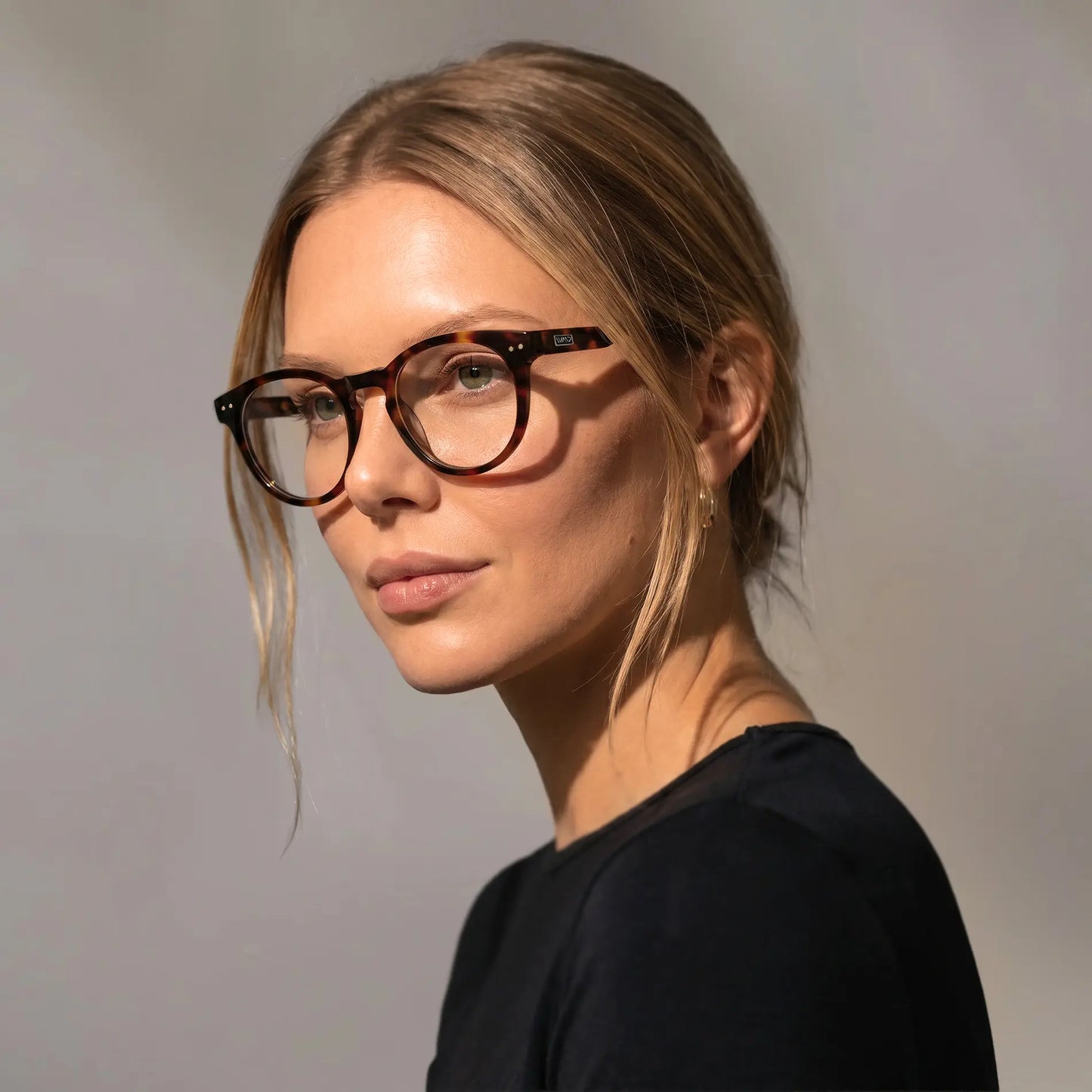 Brown Tortoise || Woman wearing Round Prescription Glasses with Brown Tortoise Frame and Clear Lenses on a white background