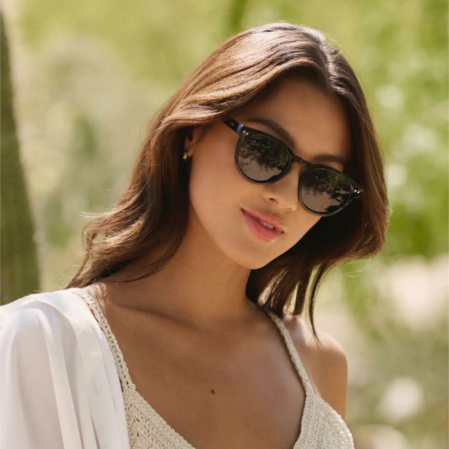 Black Case || Woman wearing black round frame sunglasses with dark lenses outdoors in natural light