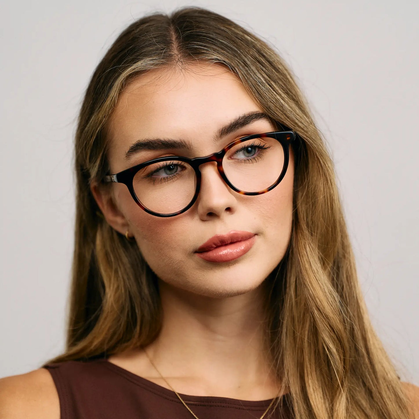 Brown Tortoise || Female Model wearing Women's Round Blue Light Blocking Glasses with a Brown Tortoise Acetate Frame and Clear Lens