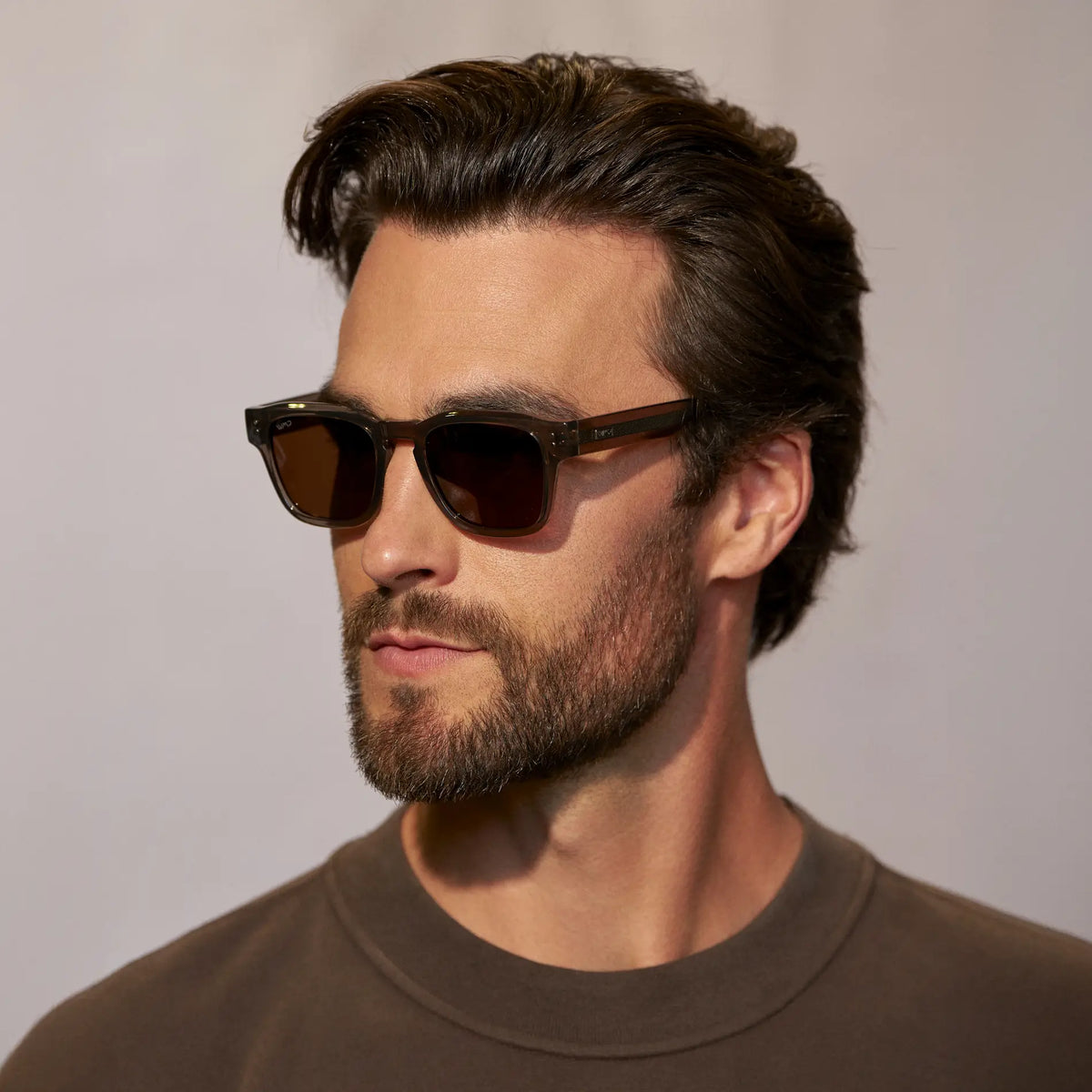 Crystal Gunmetal / Amber || Model wearing Men's Geometric Rectangular Prescription Sunglasses with Crystal Gunmetal Acetate Frame and Amber Prescription Lens