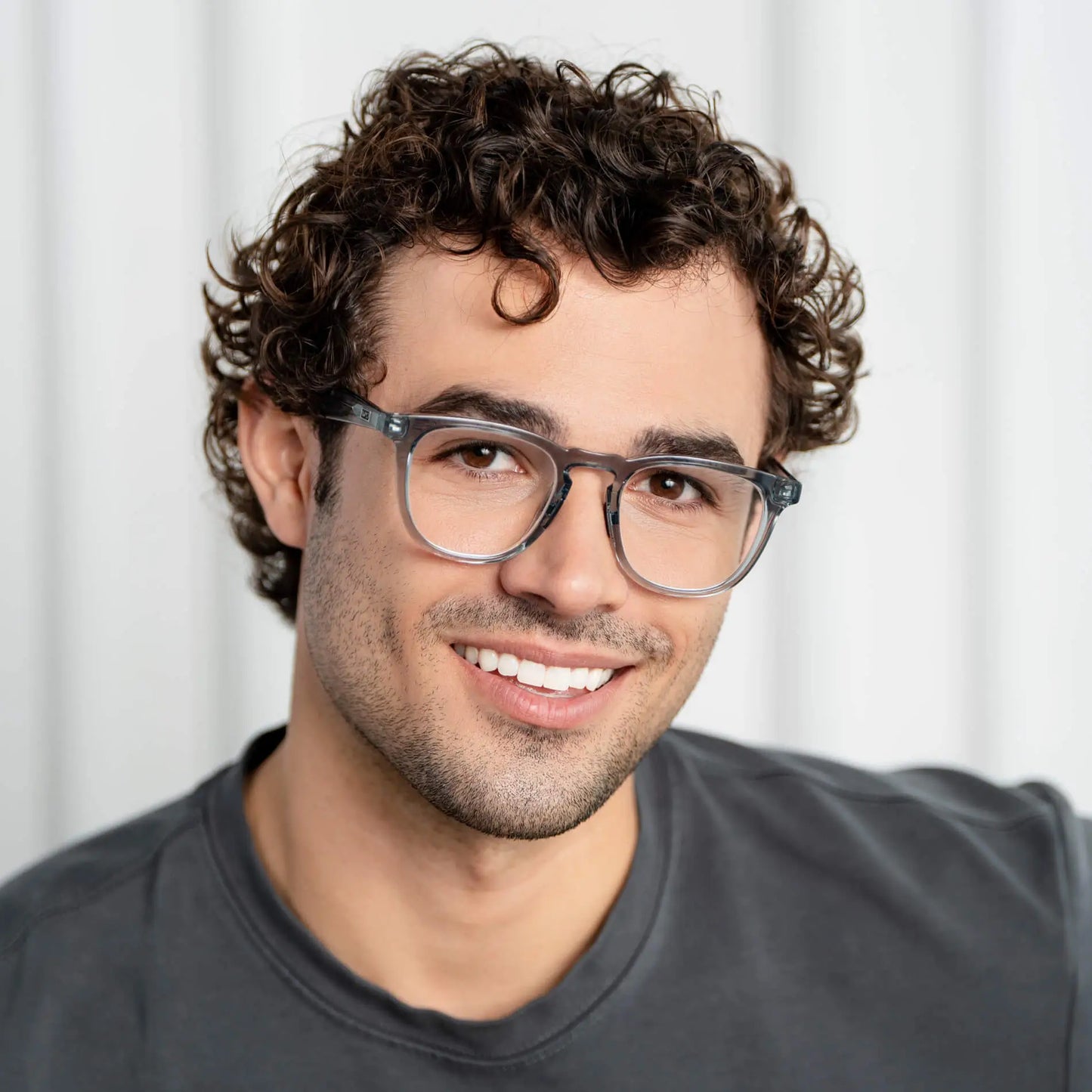 Denim Blue || Round prescription glasses with denim blue acetate frame and keyhole bridge worn by smiling man indoors