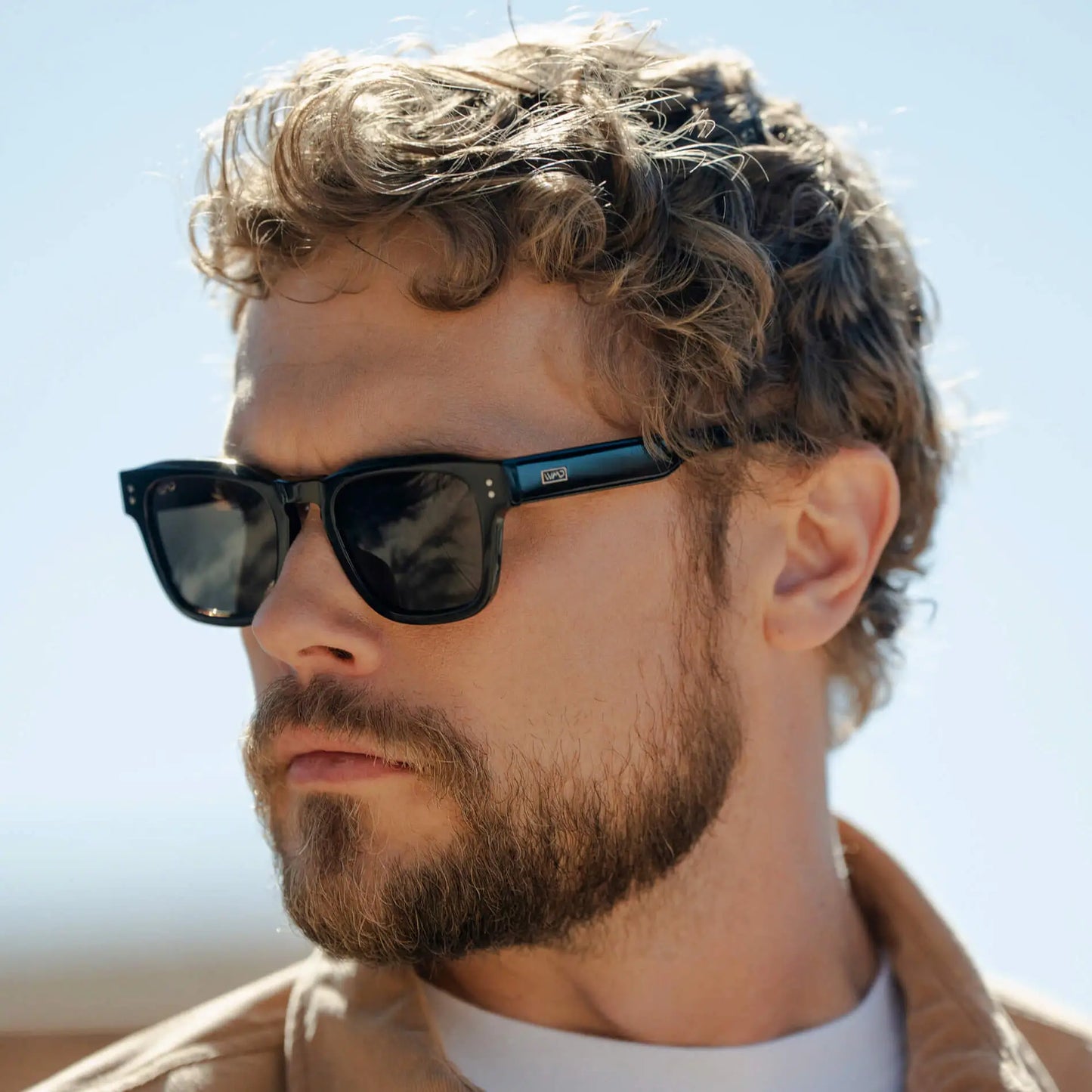 Black / Amber || Model wearing Men's Geometric Rectangular Prescription Sunglasses with Black Acetate Frame and Amber Prescription Lens