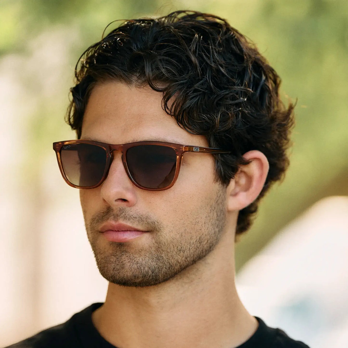 Crystal Brown / Amber || Square prescription sunglasses with crystal brown acetate frame, keyhole bridge, and amber lenses worn by man outdoors