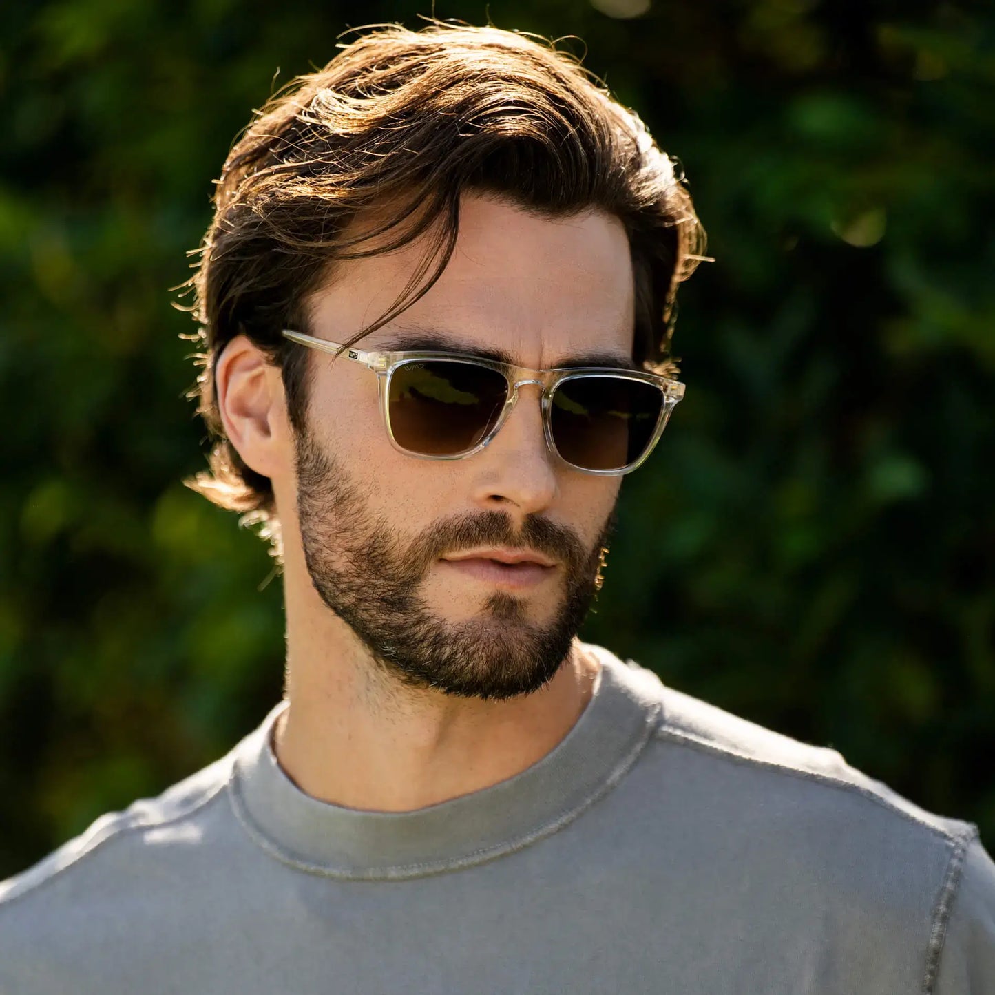 Clear / Amber || Square prescription sunglasses with clear frame, keyhole bridge, and amber lenses worn by man outdoors