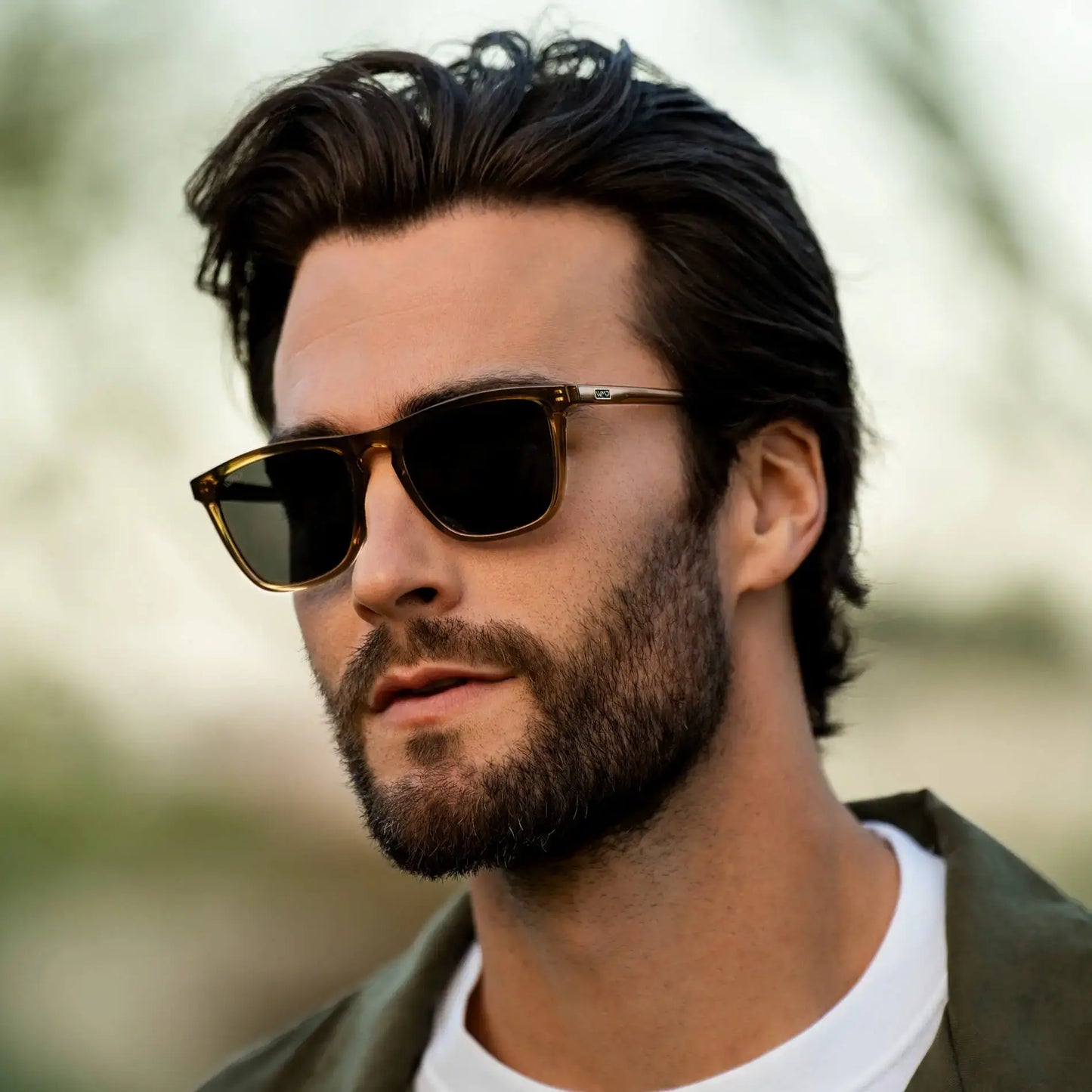 Crystal Verde / Grey || Square prescription sunglasses with crystal verde frame and grey lenses worn by man outdoors