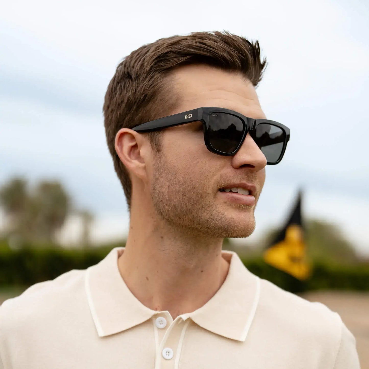 Black / Grey || Square sunglasses with a thick black acetate frame and straight temples worn by man outdoors
