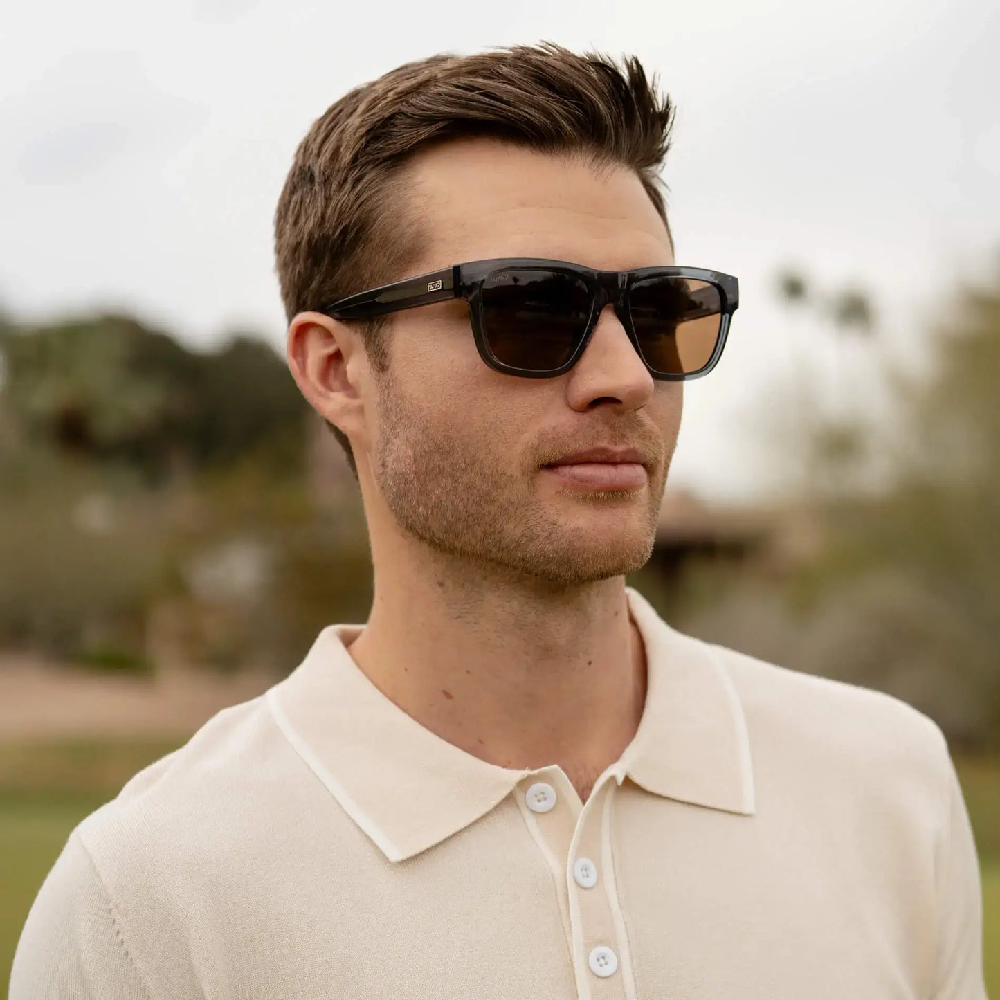 Crystal Navy Dusk / Amber || Square sunglasses with a thick blue acetate frame and straight temples worn by man outdoors