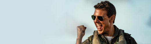 Man wearing sunglasses raising his fist and shouting in celebration