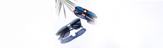Two pairs of sunglasses displayed on a white background in natural light