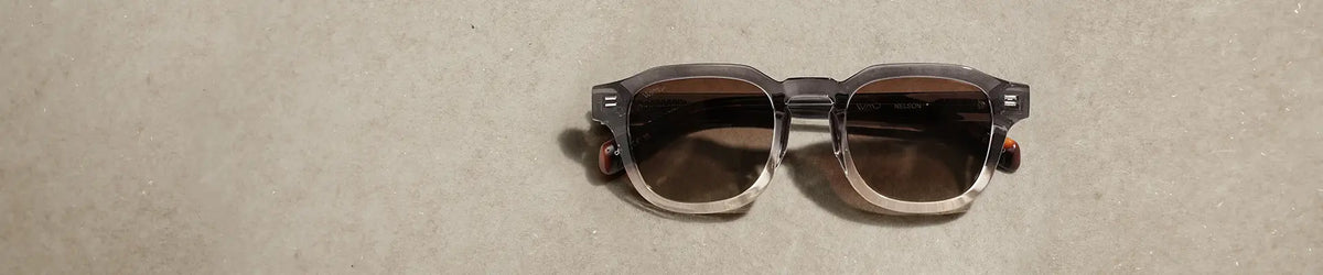 WMP Eyewear Nelson sunglasses in Graphite Horizon Grey, featuring a translucent gradient gray frame with brown lenses.