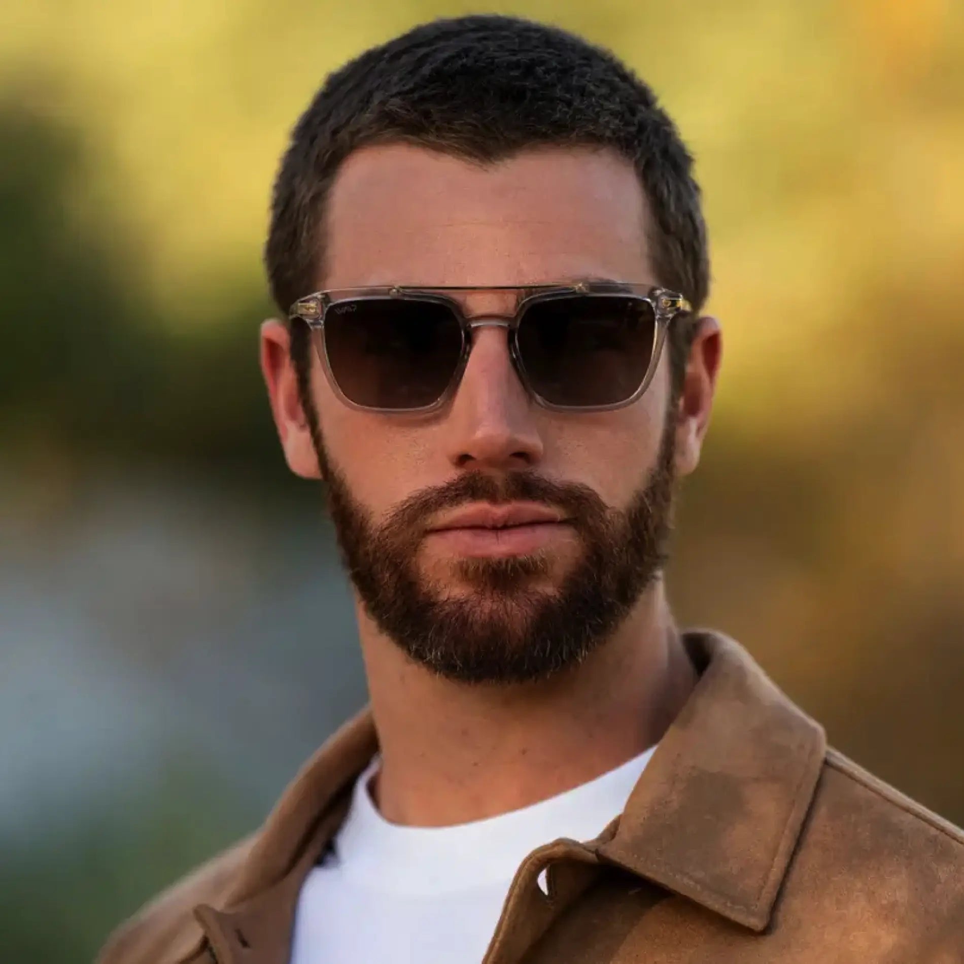 Crystal Ice Grey / Amber Lens || Square prescription sunglasses with crystal ice grey acetate frame, double bridge, and amber lenses worn by man outdoors