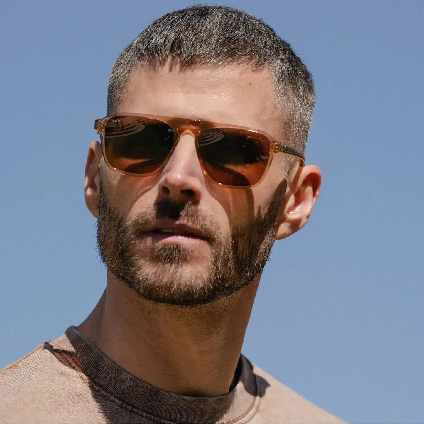 Light Crystal Brown / Amber || Single Bridge Aviator prescription sunglasses with light crystal brown acetate frame and amber lenses worn by man outdoors